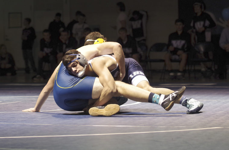 Times Observer photo by Ben Oviatt Warren's Dominic Caprino wrestles Eisenhower's Justin Hagberg at 195.